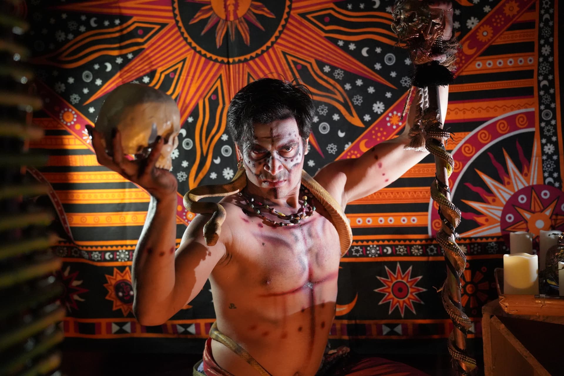 Castle of Chaos performer holding a skull in a ritual scene