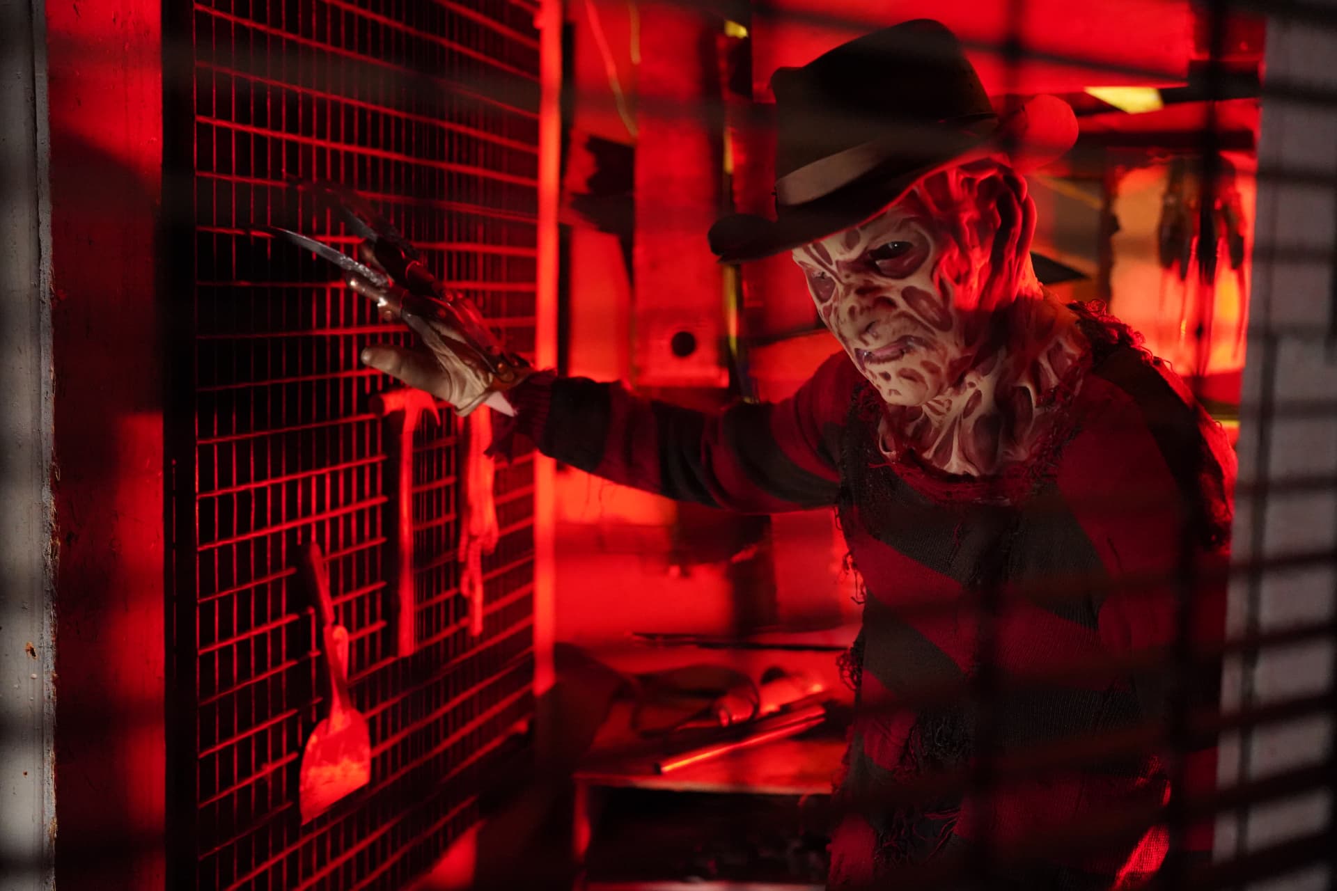Bladed nightmare character lit in deep red inside the Castle